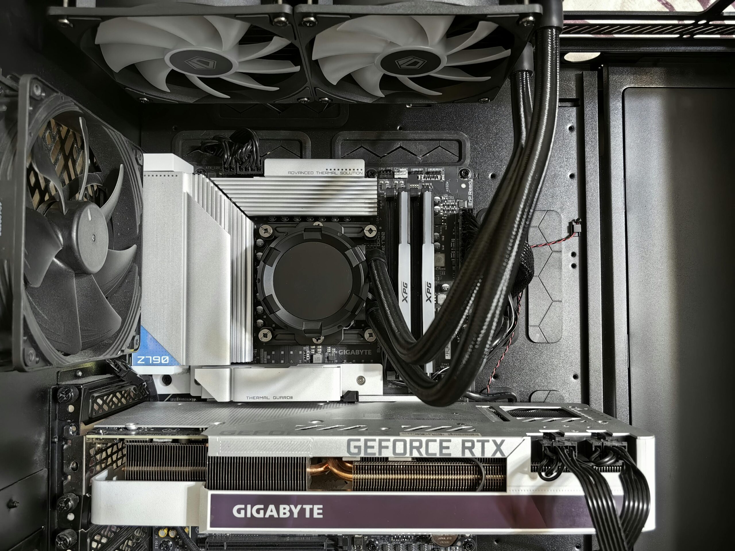 Detailed view of a custom gaming PC's interior showcasing components like RTX GPU and advanced cooling system.